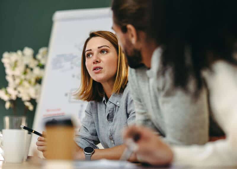 Office workers collaborating around a conference table